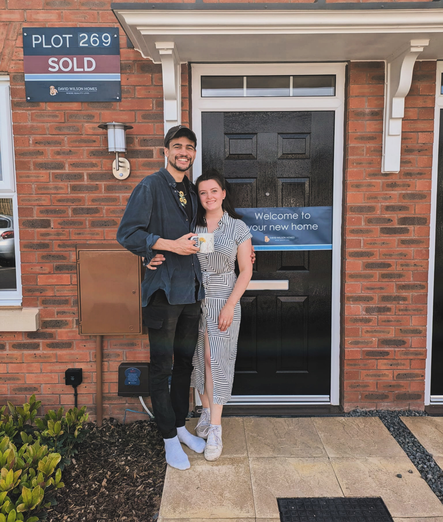 Eliza and Lewis outside their new house